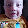 baby, child, face, smile, closeup, yellow_shirt, disney_characters, tigger, pooh, eeyore, text_on_clothing, joyful, infant, portrait, person, cute, happy, indoors, clothing, head