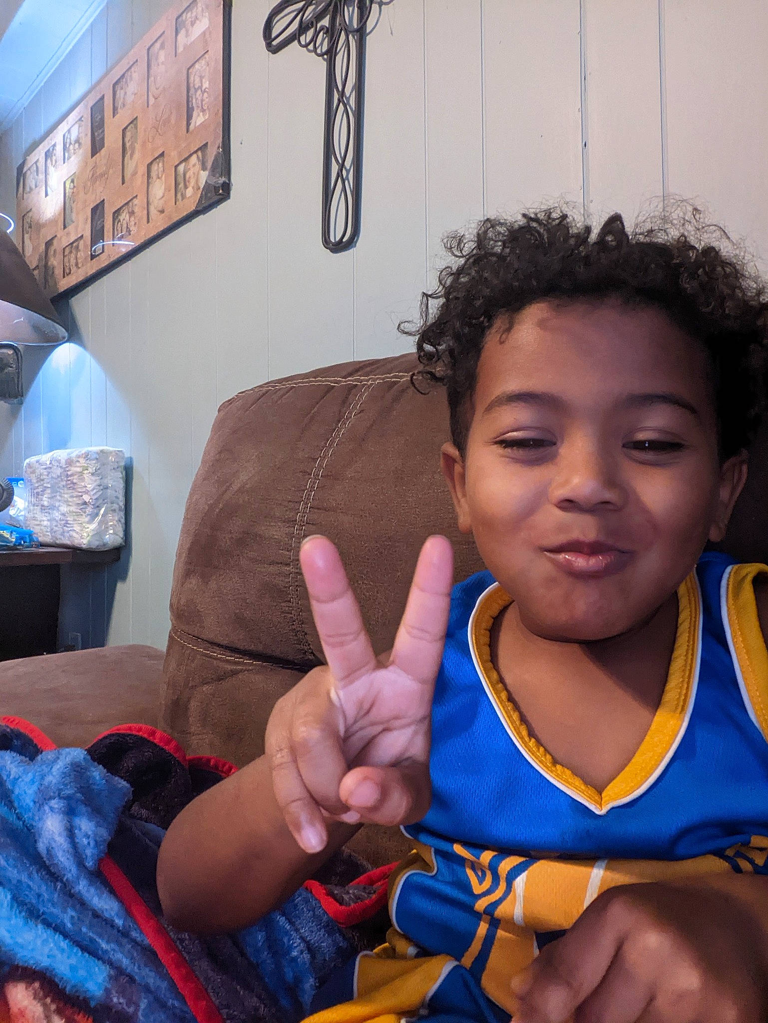 Tylan is registered to the contest to win money with this photo: arm, azure, cool, couch, electric_blue, facial_expression, finger, fun, gesture, hand, happy, joy, people, person, picture_frame, skin, smile, snapshot, sports_uniform, thumb