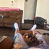 Draco is registered to the contest to win money with this photo: blanket, carpet, couch, dog, doorway, floor, french_bulldog, jacket, legs, living_room, person, relaxing, ripped_jeans, rug, shoes, sleeping_dog, socks, table, wall, water_bottle