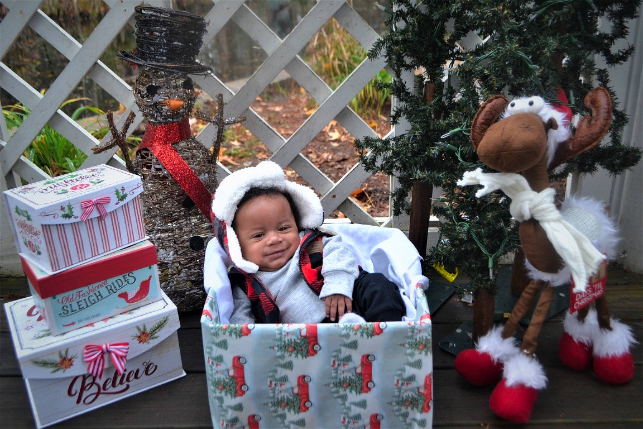 Cj is registered to the contest to win money with this photo: carmine, christmas, christmas_decoration, christmas_eve, christmas_ornament, event, fence, fictional_character, fun, fur, happy, hat, holiday, joy, ornament, person, plant, santa_claus, toddler, toy