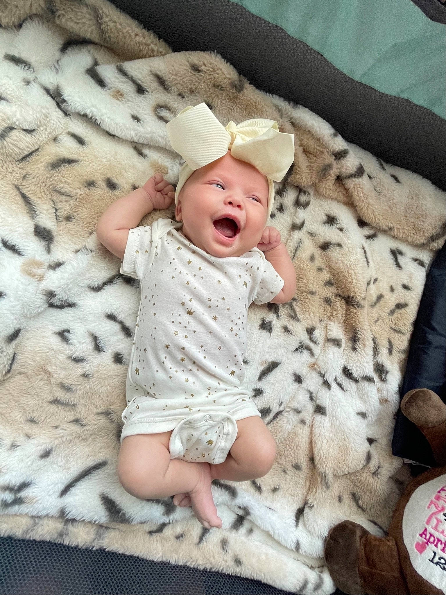 Amberley is registered to the contest to win money with this photo: baby, baby_sleeping, baby_toddler_clothing, child, comfort, face, foot, fur, head, headwear, linens, pattern, person, sitting, skin, sleeve, smile, t_shirt, textile, toddler