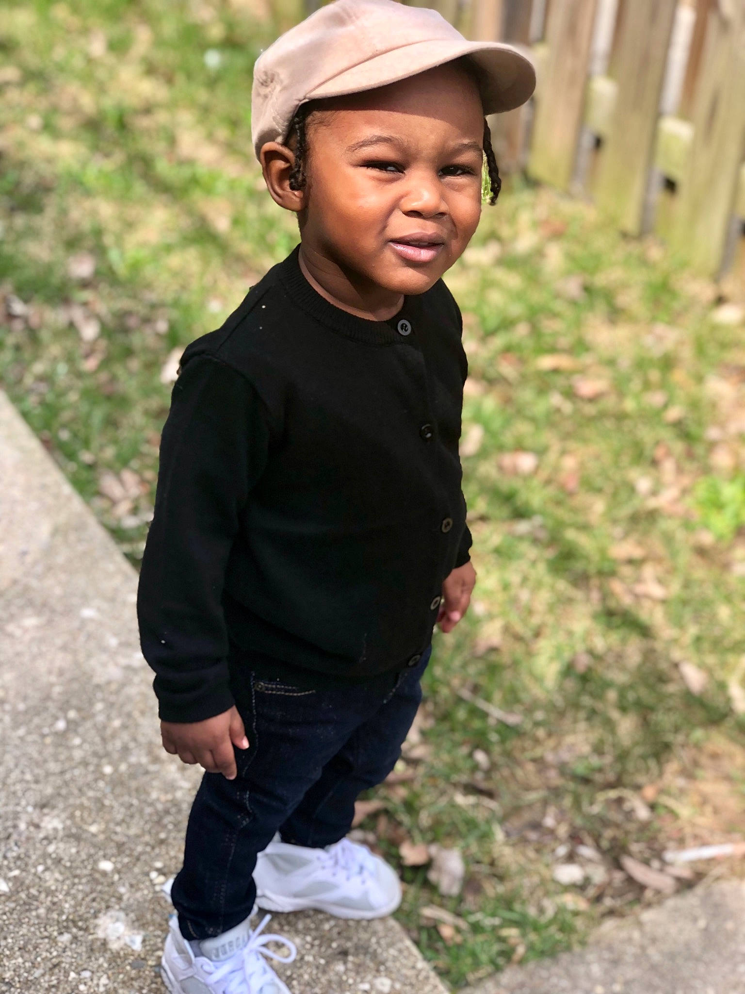 Nasir is registered to the contest to win money with this photo: cap, child, cool, headgear, headwear, male, person, photography, recreation, shoe, sleeve, smile, t_shirt