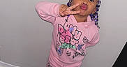 Londyn Rose is registered to the contest to win money with this photo: child, toddler, girl, portrait, standing, smiling, kissy_face, peace_sign, pink_pajamas, cartoon_clothing, braided_hair, hair_beads, sneakers, indoors, home, wooden_floor, wall, furniture, flash_photography, playful