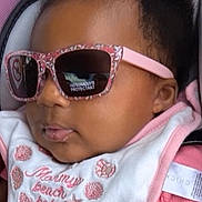 Zaleyah Eaton is registered to the contest to win money with this photo: baby, infant, child, sunglasses, pink, hair_bows, bib, car_seat, portrait, sitting, indoor, vehicle, fashion, cute, face, head, clothing, smiling, accessories, photography