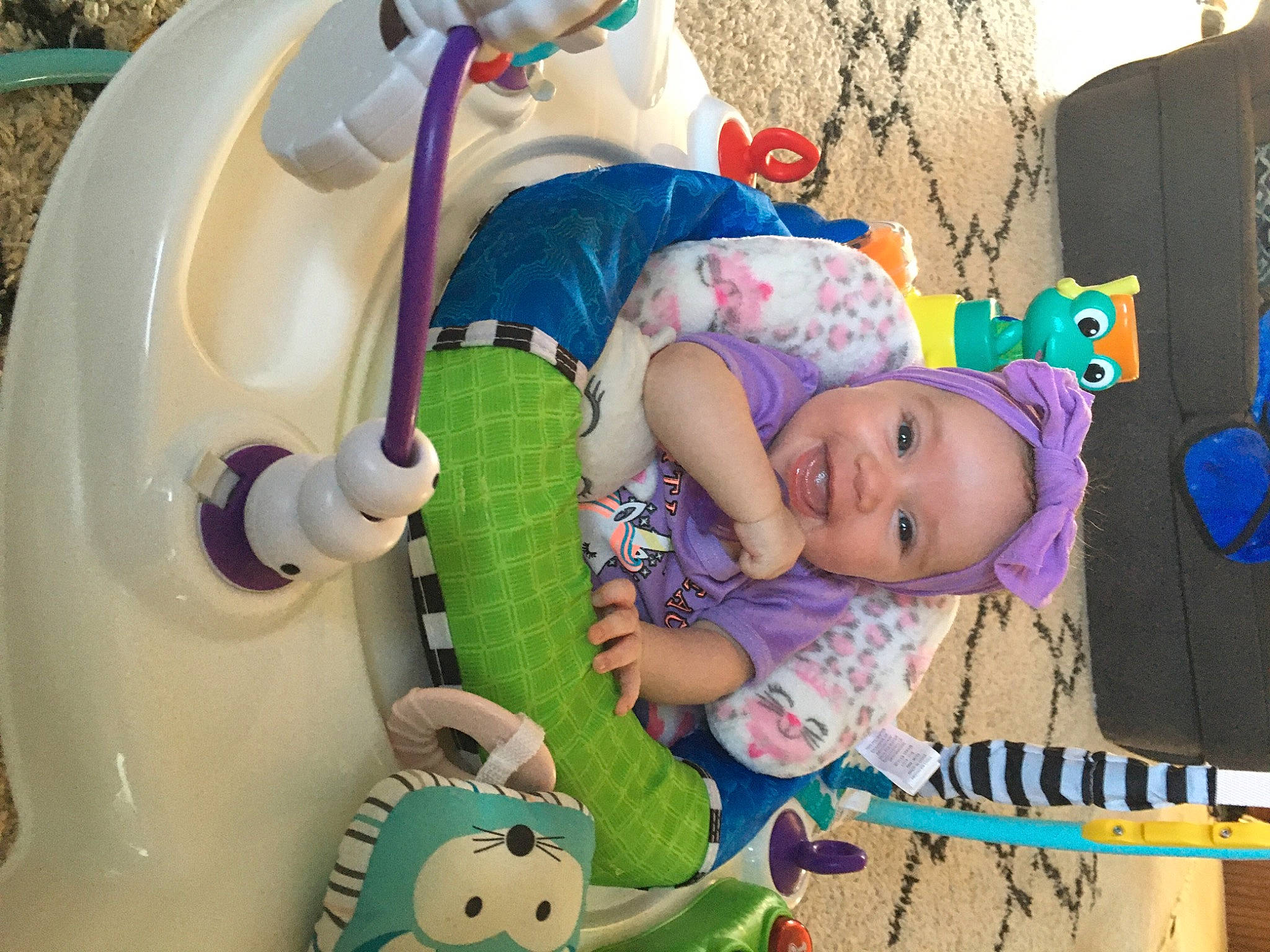 Karina is registered to the contest to win money with this photo: baby, baby_carriage, baby_products, baby_safety, baby_toddler_clothing, baby_toys, blue, cheek, child, fun, green, head, headgear, headwear, person, pink, product, purple, skin, textile