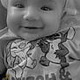 baby, smile, drool, shirt, cartoon, stitch, angel, closeup, black_and_white, child, face, happy, infant, clothing, text, toddler, cute, portrait, lying_down, soft