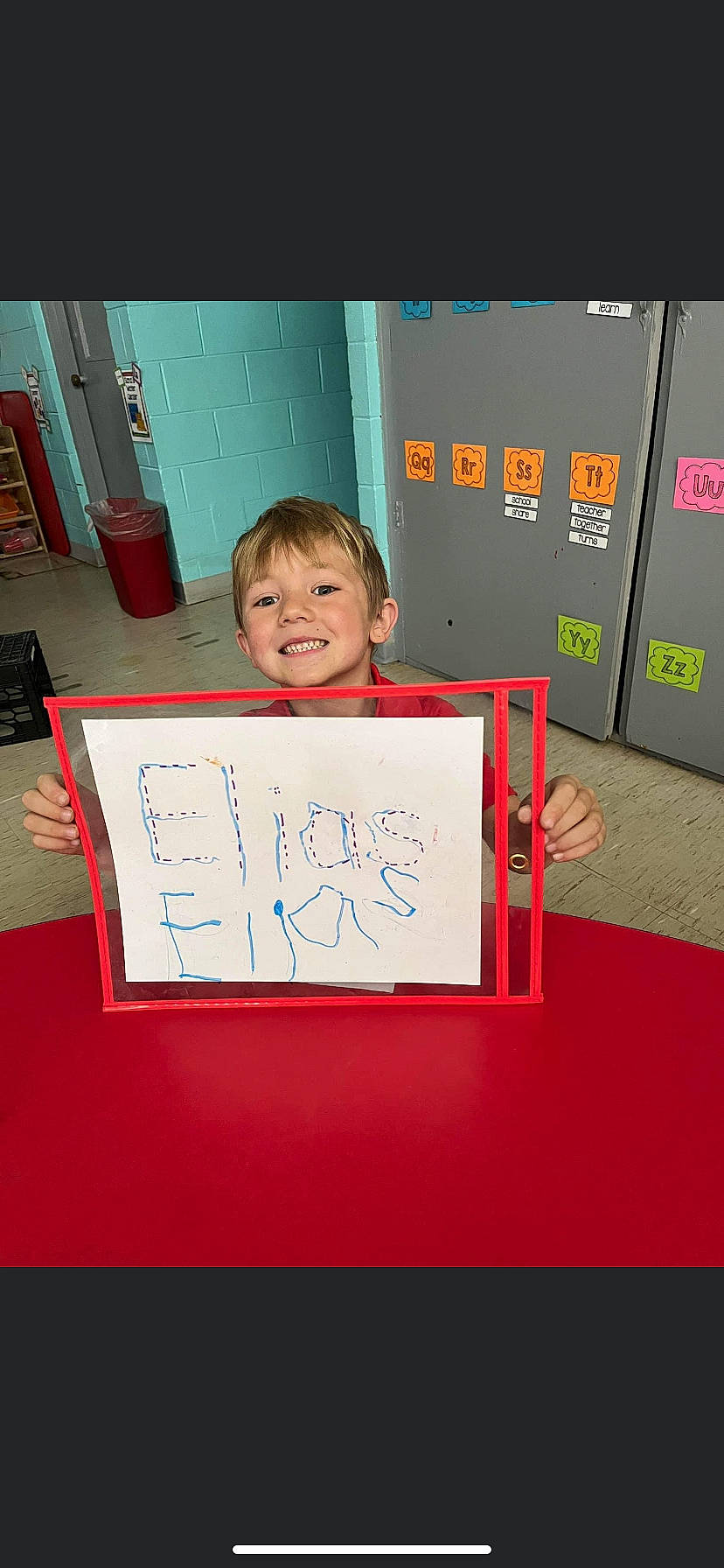 Elias is registered to the contest to win money with this photo: child, electric_blue, event, flooring, font, fun, handwriting, happy, joy, magenta, person, pink, rectangle, room, smile, toddler