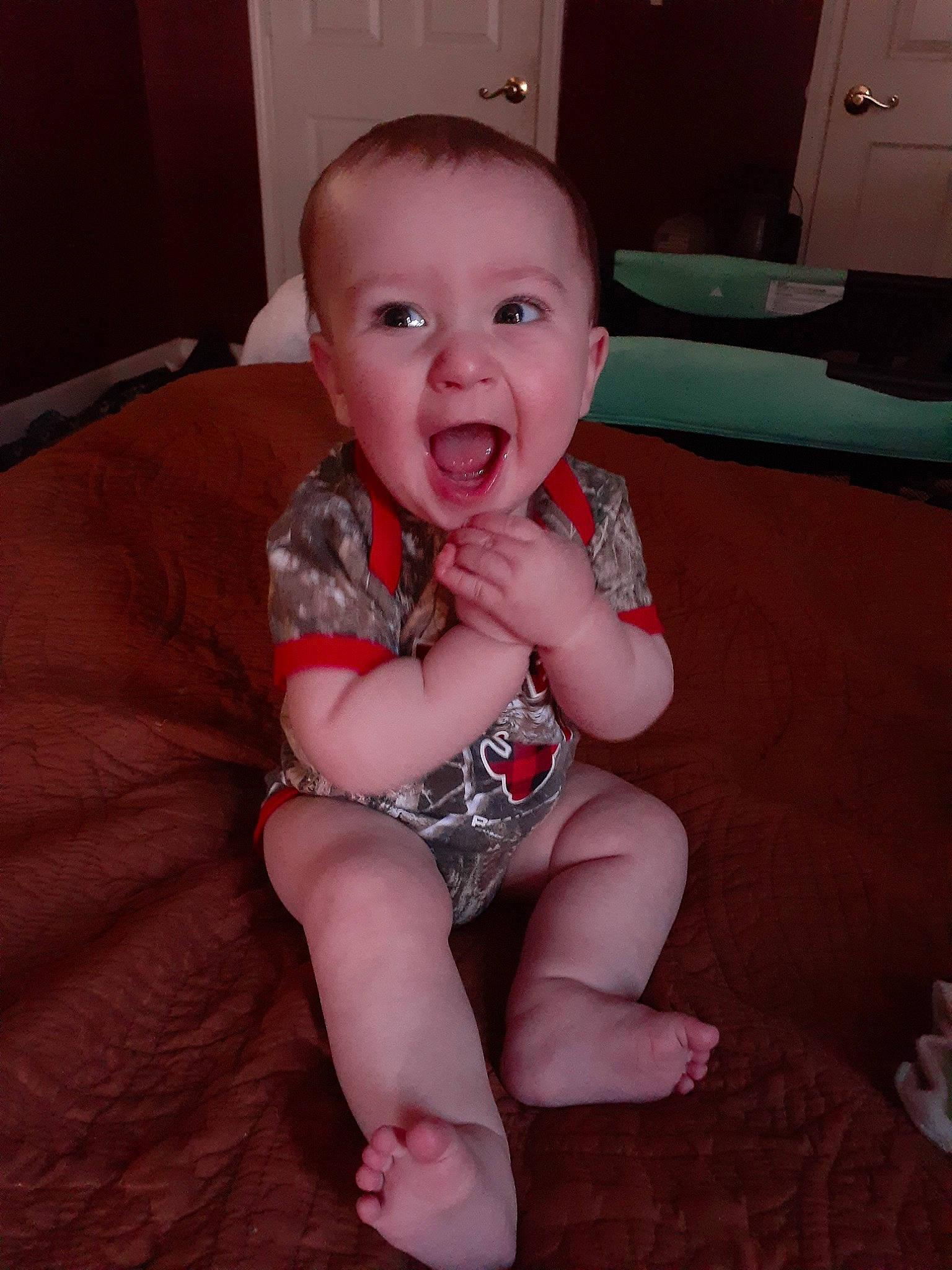 Brixton is registered to the contest to win money with this photo: arm, baby, cheek, child, eye, facial_expression, finger, head, leg, mouth, person, sitting, skin, smile, thumb, toddler