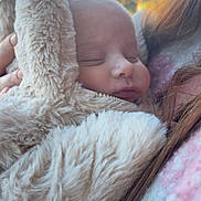 Alfie joined the competition — help win amazing prizes! baby, sleeping, fluffy, bunny_ears, coat, person, closeup, soft_texture, outdoor, sunlight, warm_clothing, face, head, child, portrait, cuddly, resting, human, young, cozy