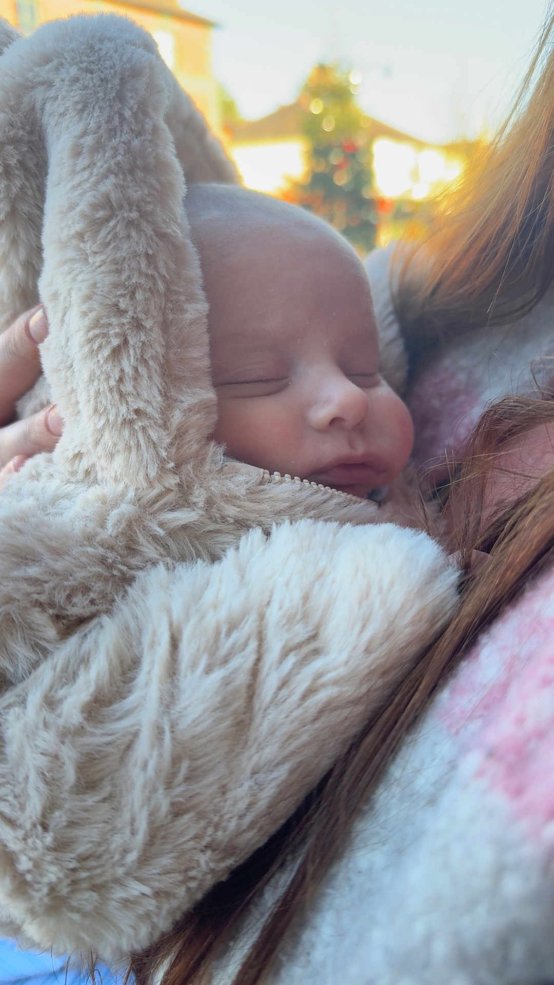 Alfie joined the competition — help win amazing prizes! baby, sleeping, fluffy, bunny_ears, coat, person, closeup, soft_texture, outdoor, sunlight, warm_clothing, face, head, child, portrait, cuddly, resting, human, young, cozy