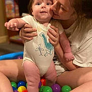Asher joined the competition — help win amazing prizes! baby, child, woman, person, ball_pit, colorful_balls, dinosaur_onesie, indoor, bookshelf, sitting, smiling, holding, legs, face, playtime, toys, happy, family, cute, fun