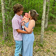 Asher joined the competition — help win amazing prizes! child, baby, couple, forest, trees, nature, outdoor, love, family, affection, holding, kiss, casual_clothing, greenery, young_adult, parent, infant, jeans, dress, intimate