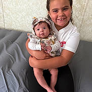 Rayleigh joined the competition — help win amazing prizes! baby, child, smile, portrait, indoor, bed, holding, person, face, happy, sitting, clothing, headwear, infant, family, cuddling, cute, young, toddler, wall