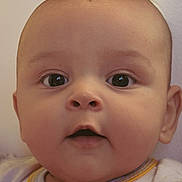 Brody is registered to the contest to win money with this photo: baby, face, close_up, infant, child, curious, eyes, mouth, expression, skin, clothing, white, yellow, portrait, cute, adorable, young, head, innocence, soft