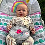 Madilynn is registered to the contest to win money with this photo: baby, infant, smile, pajamas, animal_print, baby_seat, rainbow, sun, cloud, outdoor, grass, happy, child, cute, seatbelt, colorful, pattern, person, portrait, young