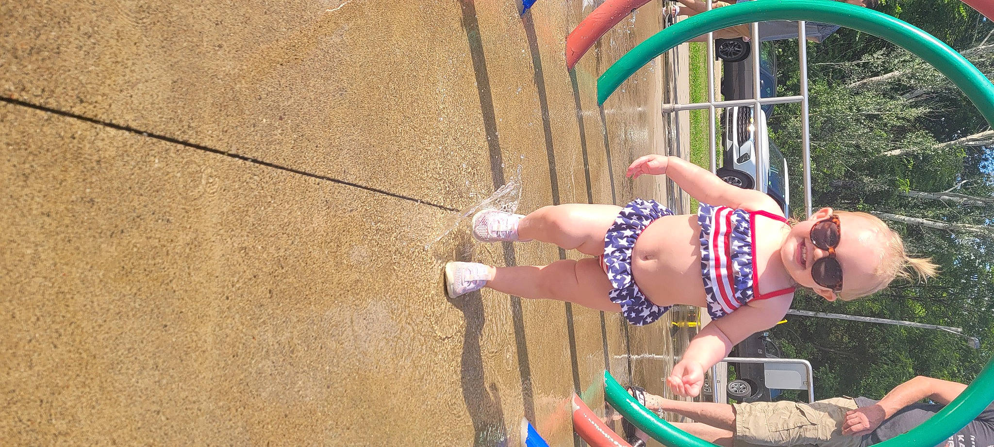 Hadley is registered to the contest to win money with this photo: abdomen, barefoot, child, competition, entertainment, event, fun, grass, happy, human_leg, joy, knee, leisure, performing_arts, person, recreation, sandal, shorts, thigh, tree