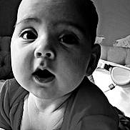 Lilly is registered to the contest to win money with this photo: baby, beverage, bodypart, coffee, coffeecup, cup, cutlery, face, finger, frown, hand, head, indoors, mouth, newborn, person, photography, portrait, sad, spoon