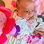 baby, blanket, butterflies, child, closeup, colorful, cozy, cute, expression, face, hearts, indoor, infant, patterned_clothing, pink, plush_toy, portrait, purple, soft_toy, young