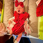 Mélodie a rejoint le concours — aidez-le/la à gagner de superbes lots ! baby, infant, red_dress, bow, yawning, cushion, changing_table, white_socks, tulle, cute, indoors, person, headwear, clothing, newborn, fabric, soft, sleepy, toddler, child