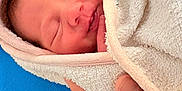 Mélodie a rejoint le concours — aidez-le/la à gagner de superbes lots ! newborn, baby, towel, hand, sleeping, closeup, skin, wrapped, infant, peaceful, soft, blue_background, portrait, cute, tiny, fresh, human, resting, newborn_baby, gentle