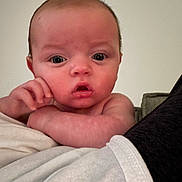 Roman joined the competition — help win amazing prizes! baby, infant, face, skin, arm, expression, curious, portrait, indoors, person, young, child, closeup, resting, soft, blanket, couch, human, head, eyes