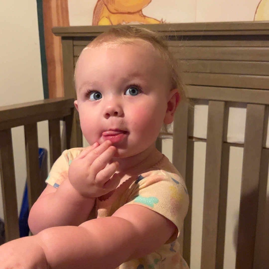 Morgan is registered to the contest to win money with this photo: animal, baby, bear, bed, bodypart, cradle, crib, face, finger, furniture, hand, handrail, head, indoors, infantbed, nursery, person, photography, portrait, room