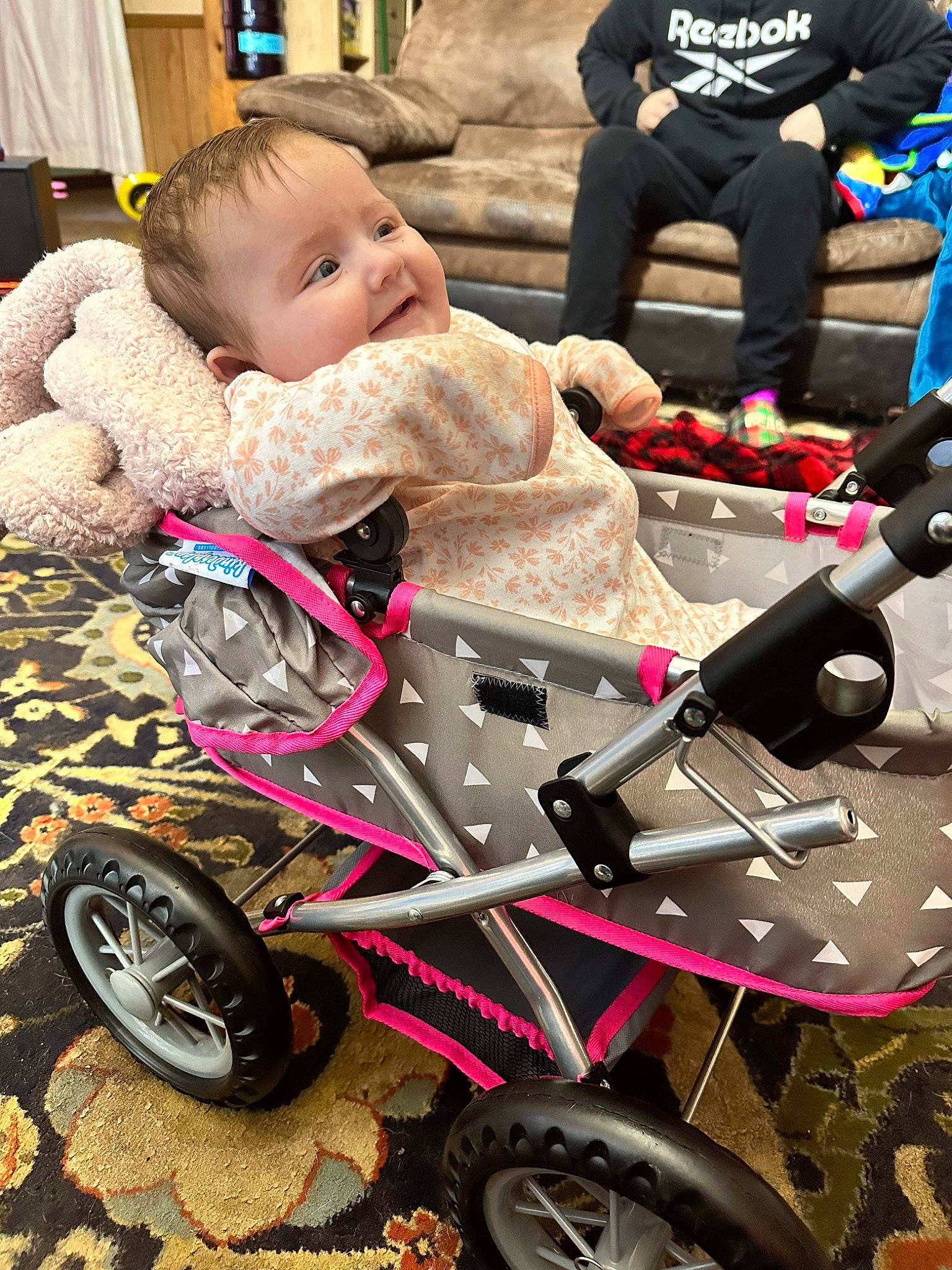 Salem is registered to the contest to win money with this photo: auto_part, automotive_tire, baby, baby_carriage, baby_products, baby_toddler_clothing, child, comfort, curtain, fun, motor_vehicle, person, photograph, riding_toy, sitting, smile, snapshot, tire, toddler, vehicle