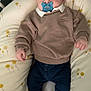 Paul participe au concours pour gagner de l'argent avec cette photo : baby, bed, child, clothing, comfort, crib, cushion, cute, face, feet, hands, indoor, infant, pacifier, pants, portrait, resting, socks, sweater, young