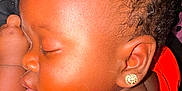 Daemir Jones is registered to the contest to win money with this photo: baby, sleeping, child, earring, red_shirt, curly_hair, closeup, face, peaceful, infant, skin, portrait, cute, adorable, resting, young_child, indoor, soft_light, head, person