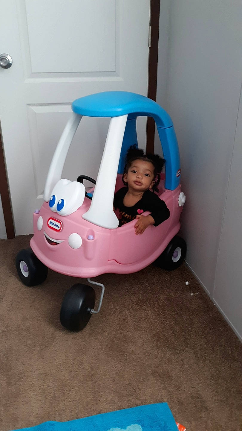 Serenity is registered to the contest to win money with this photo: baby_carriage, baby_products, baby_toys, child, person, pink, play, product, riding_toy, toddler, toy, vehicle