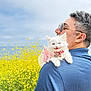 man, cat, kitten, white_cat, sunglasses, blue_shirt, pink_bow, flower_field, yellow_flowers, outdoor, nature, pet, animal, happy, portrait, shoulder, grass, sky, daylight, smiling