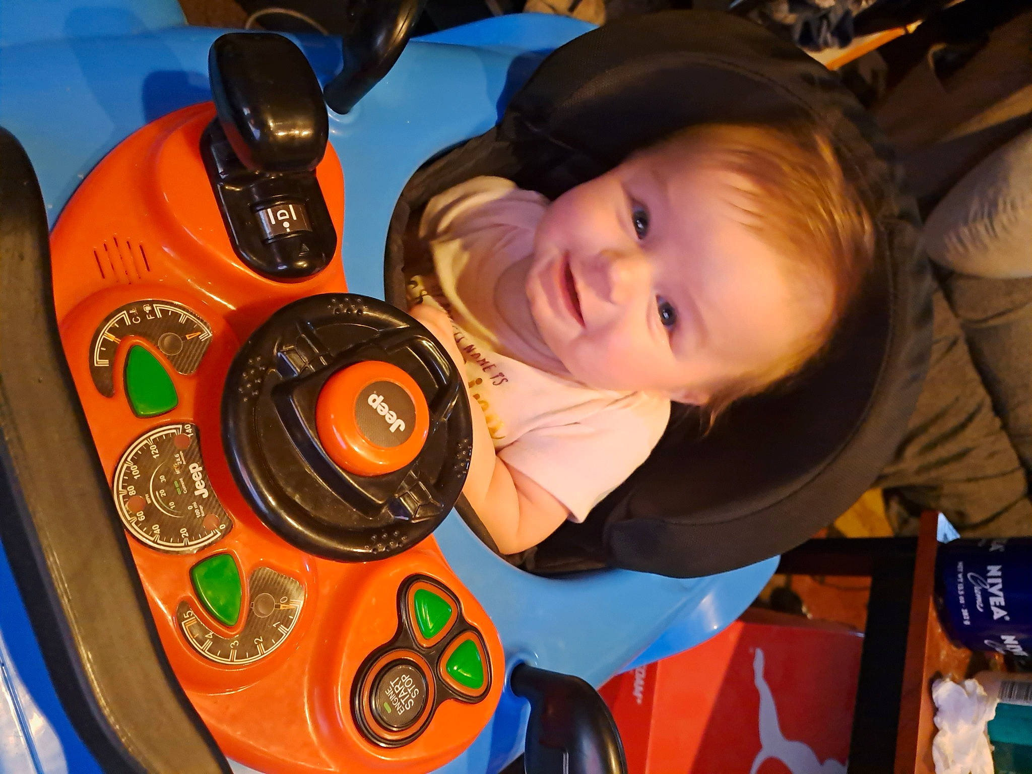 Leona is registered to the contest to win money with this photo: audio_equipment, auto_part, automotive_design, automotive_tire, automotive_wheel_system, baby, child, electric_blue, fun, hat, joy, leisure, motor_vehicle, person, product, recreation, smile, space, steering_wheel, toddler