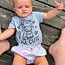 baby, barefoot, cartoon, casual, child, clothing, cute, expression, funny_text, infant, legs, outdoor, person, planks, shirt, sitting, skin, summer, tattoo, wooden_deck