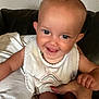 Kadence joined the competition — help win amazing prizes! baby, bib, closeup, clothing, couch, expression, face, fingers, hand, happy, holding, human, indoor, infant, person, portrait, seated, skin, smile, toes