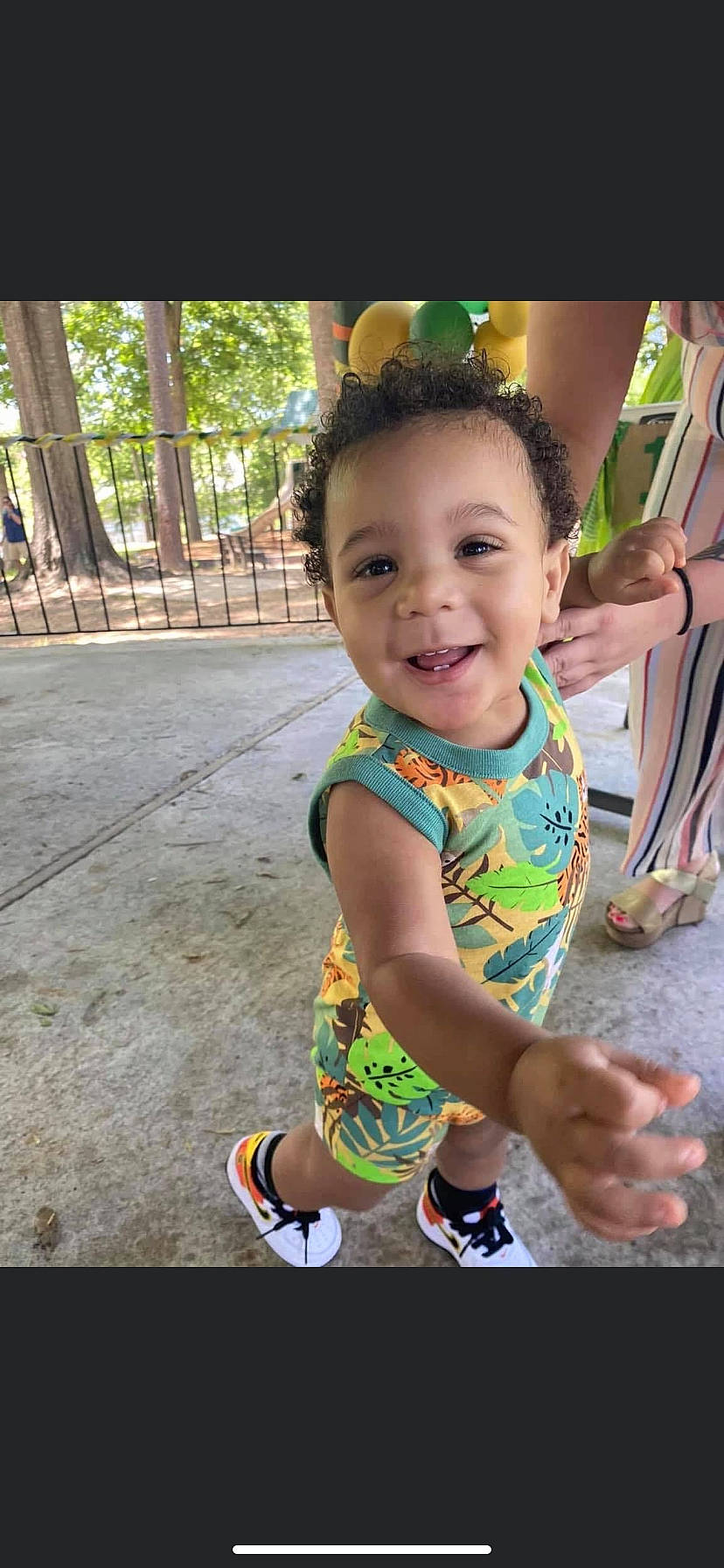 Dakota Shown Secrest joined the competition — help win amazing prizes! baby, baby_toddler_clothing, child, event, fence, fun, grass, happy, joy, leisure, person, play, recreation, sandal, shorts, sitting, skin, smile, sunglasses, toddler