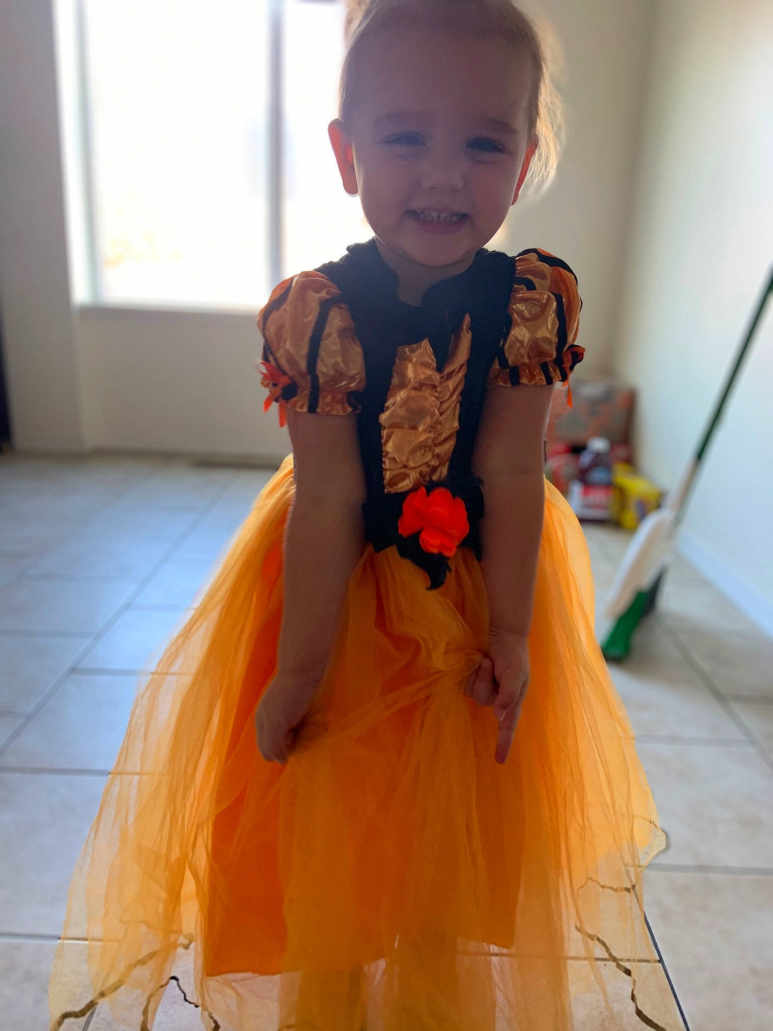 Octavia is registered to the contest to win money with this photo: baby_toddler_clothing, bridal_party_dress, child, day_dress, dress, event, face, fashion_design, flooring, formal_wear, happy, iris, joy, neck, one_piece_garment, orange, peach, person, sleeve, smile