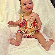 Moya joined the competition — help win amazing prizes! baby, babylaughing, bed, bodypart, clothing, cushion, dress, face, finger, furniture, hand, happy, head, homedecor, person, photography, portrait, shorts, sitting, smile