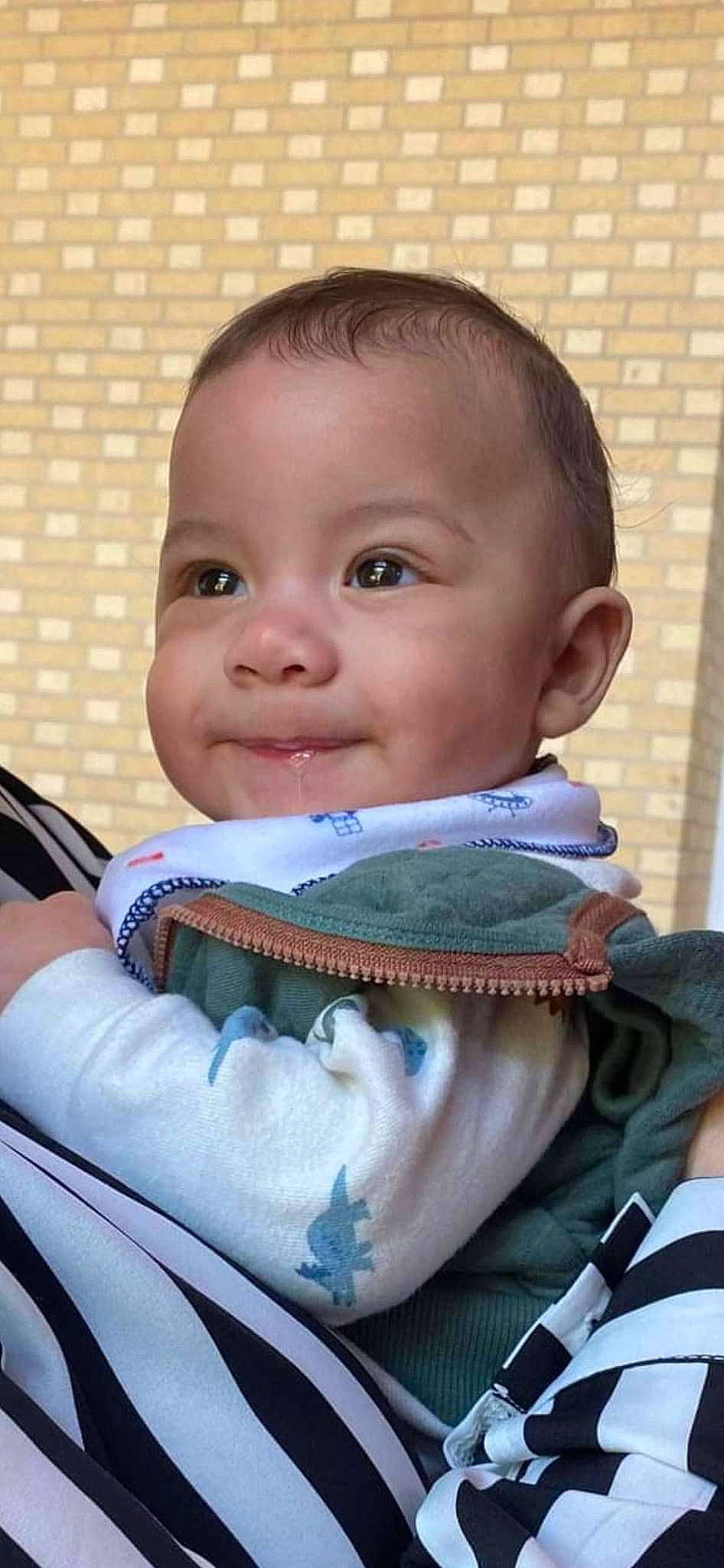 Armoni is registered to the contest to win money with this photo: baby, baby_toddler_clothing, cheek, child, comfort, eyebrow, eyelash, finger, happy, iris, jaw, joy, mouth, neck, nose, person, personal_protective_equipment, sitting, skin, sleeve