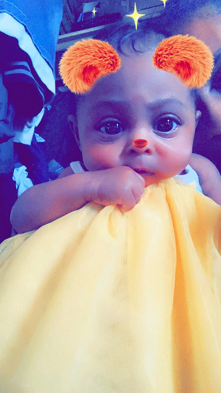 Elaine is registered to the contest to win money with this photo: baby, cheek, child, doll, ear, eye, fictional_character, headgear, person, purple, toddler, toy, yellow