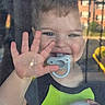 Kaison joined the competition — help win amazing prizes! toddler, child, smile, hand, pacifier, window, glass, green_shirt, indoor, outdoor, face, blue_eyes, short_hair, holding, happy, baby, person, daylight, reflection, playful