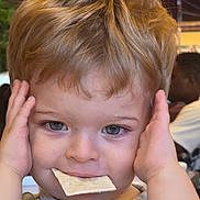Kaison joined the competition — help win amazing prizes! toddler, child, face, hands, cracker, blonde_hair, blue_eyes, cute, playful, indoor, portrait, expression, smile, casual_clothing, person, young_child, closeup, headshot, innocence, mischievous