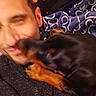 man, dog, blur, close_up, affection, indoor, blanket, pattern, face, pet, canine, human, cuddle, warmth, cozy, love, interaction, snout, fur, head