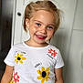 Zlata participe au concours pour gagner de l'argent avec cette photo : apparel, blonde_hair, child, clothing, cute, earrings, eyewear, face, fashion, flower_print, girl, happy, indoor, person, portrait, smiling, standing, tshirt, yellow_skirt, young