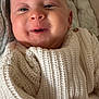 baby, infant, smile, knit_sweater, blanket, bedding, closeup, face, eyes, mouth, cheeks, newborn, cozy, soft_texture, skin, head, ear, button, happy, portrait