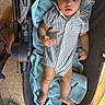 baby, casual, child, comfort, curious, fabric, face, footwear_free, hand, hat, headwear, indoors, infant, legs, portrait, relaxation, skin, striped_clothing, stroller, towel