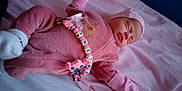 Coline Et Matthew participe au concours pour gagner de l'argent avec cette photo : newborn, baby, sleeping, pink_clothing, pacifier, beads, bed, blanket, hat, gloves, soft_texture, infant, cute, peaceful, portrait, closeup, indoor, child, resting, cozy