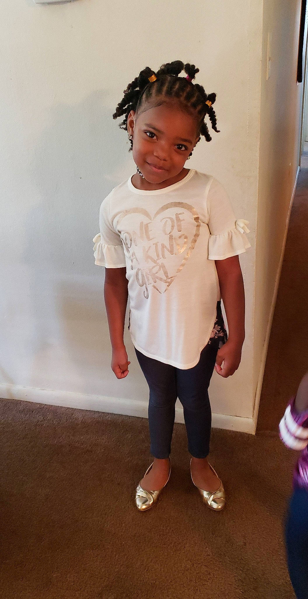 Damyla is registered to the contest to win money with this photo: child, child_model, clothing, footwear, hair_accessory, hairstyle, headband, joy, neck, person, shoe, shoulder, sleeve, sportswear, standing, t_shirt, toddler, top, white