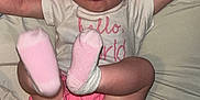 Josetta joined the competition — help win amazing prizes! baby, infant, pink_headband, pink_shorts, socks, tongue_out, lying_down, bed, blanket, playful, child, cute, happy, clothing, person, face, arms_up, feet, diaper, home