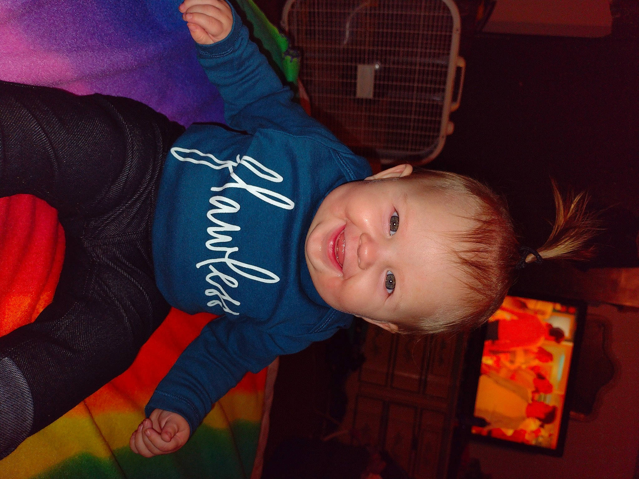 Georgia is registered to the contest to win money with this photo: baby, baby_products, baby_toddler_clothing, cheek, child, comfort, electric_blue, fun, happy, joy, mouth, orange, person, room, sitting, sleeve, smile, thumb, toddler, under_exposed