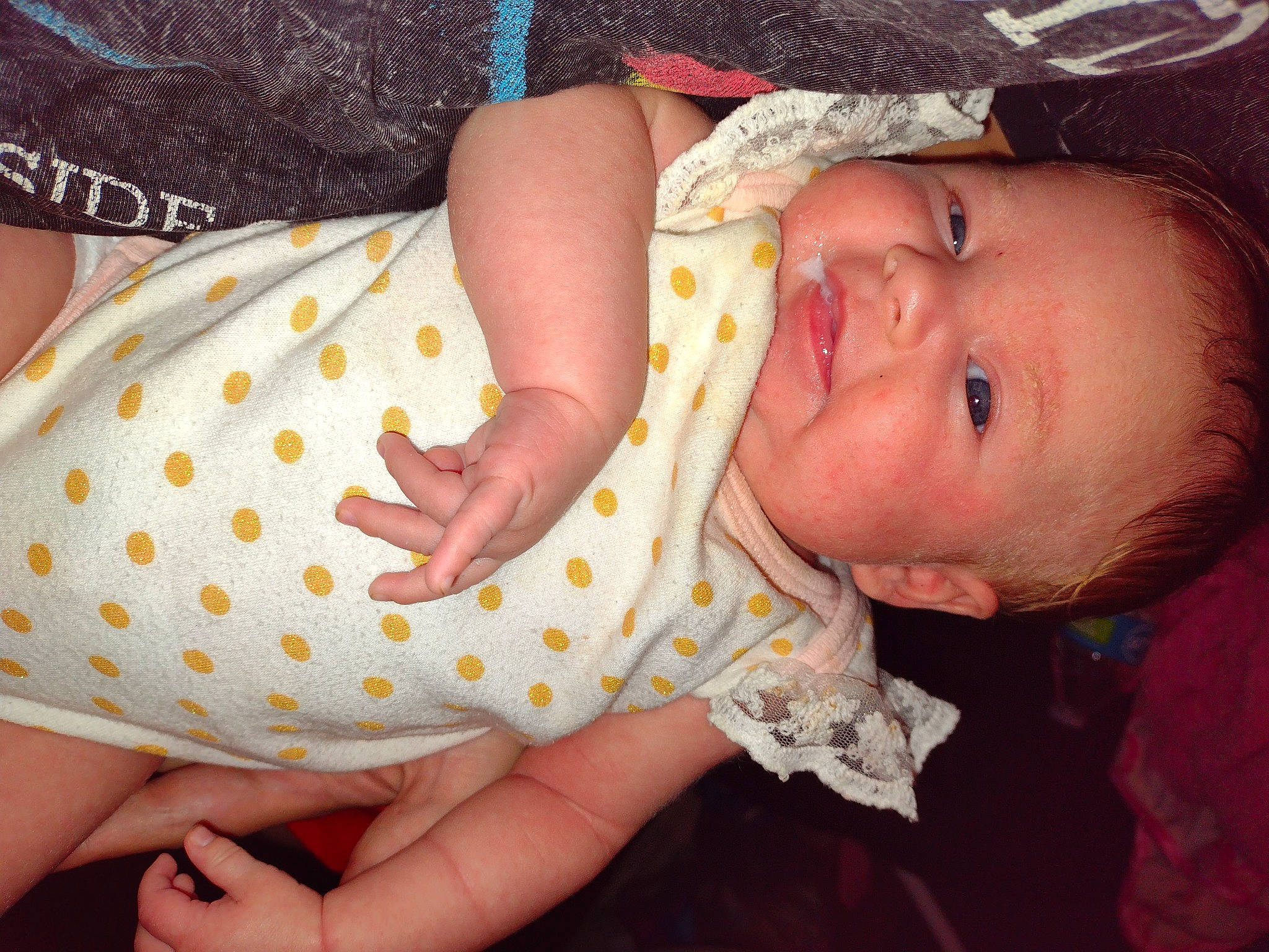 Georgia is registered to the contest to win money with this photo: baby, baby_toddler_clothing, cheek, child, eyelash, facial_expression, finger, gesture, hand, happy, lip, mouth, nail, nose, orange, person, pink, skin, sleeve, thumb